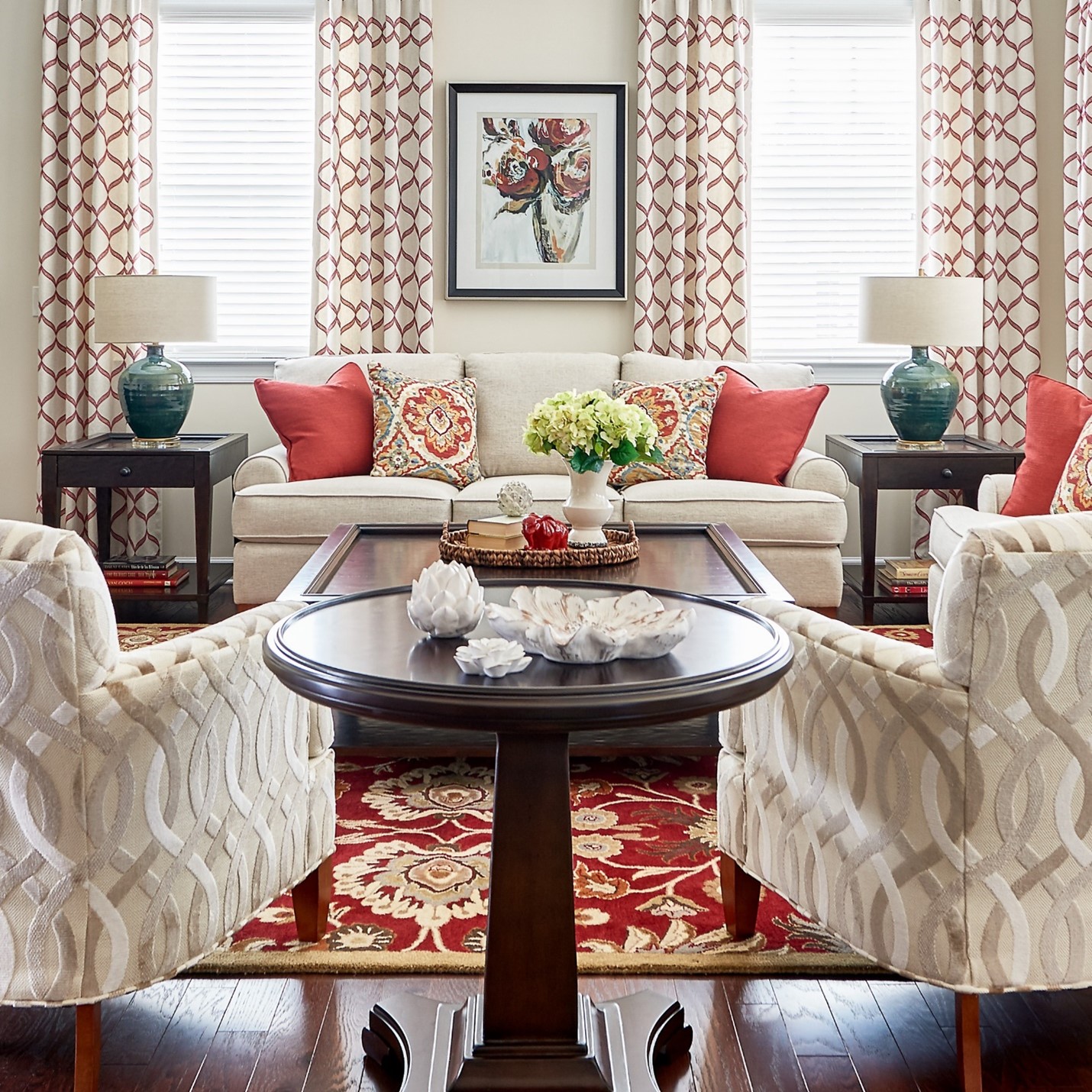 Family Room with nuetral sofa, textured chair fabric and bold red pillows and rug