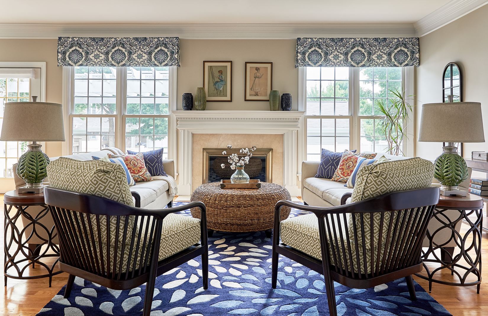 Family room with central rattan coffee table and blue rug