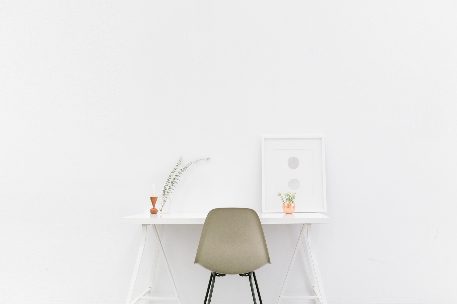 White room with desk, chair and minimal furnishings